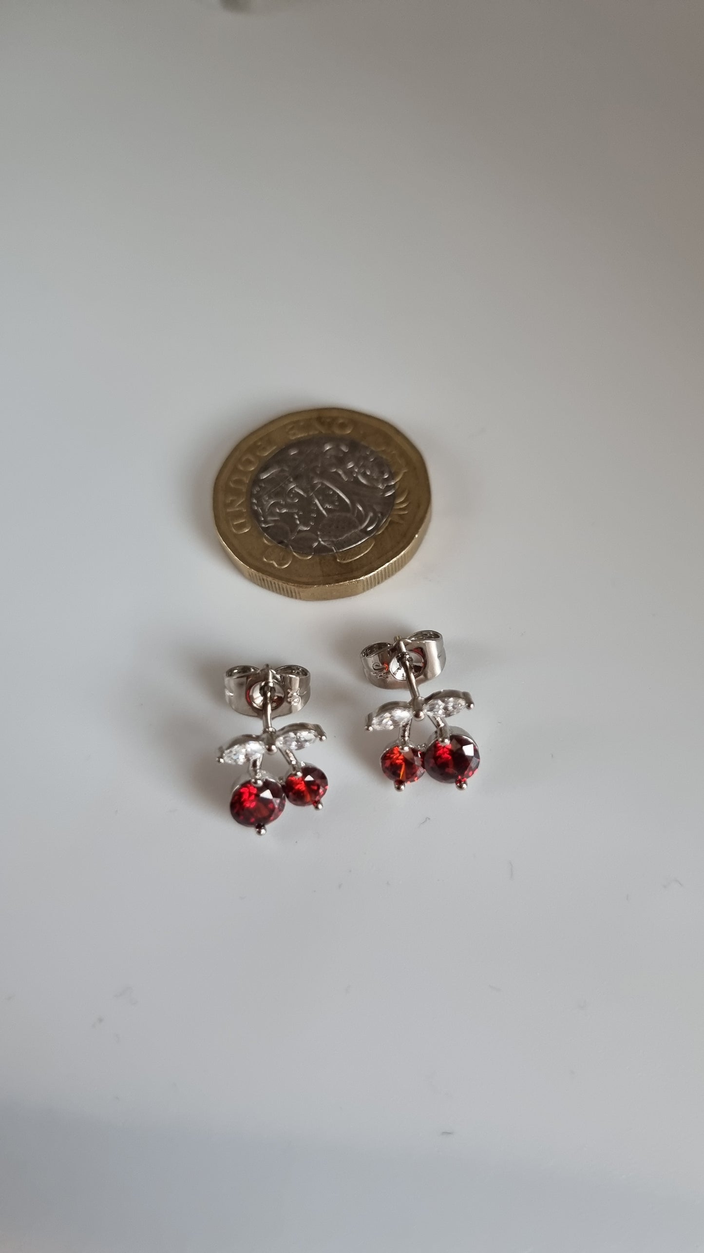 Platinum plated stud earrings with granet color zircon stone and white