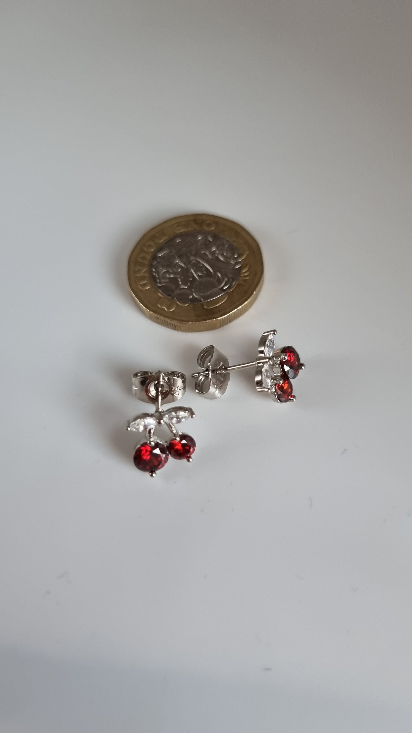 Platinum plated stud earrings with granet color zircon stone and white